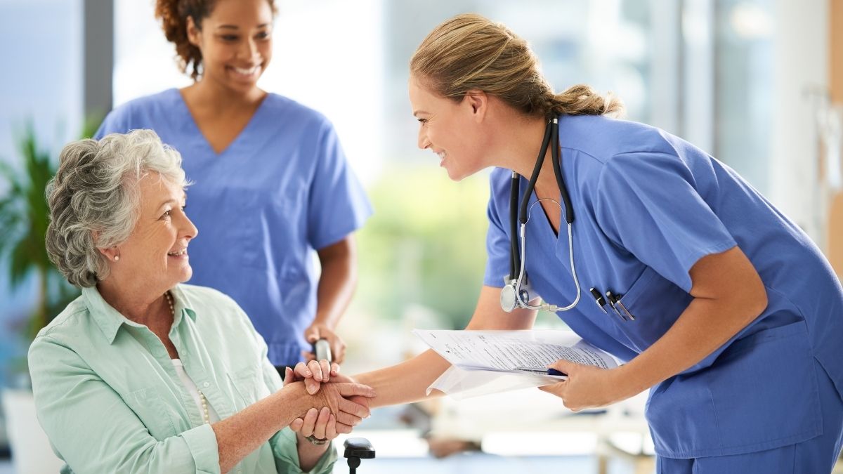 Nurse caring for an older patient in a hospital